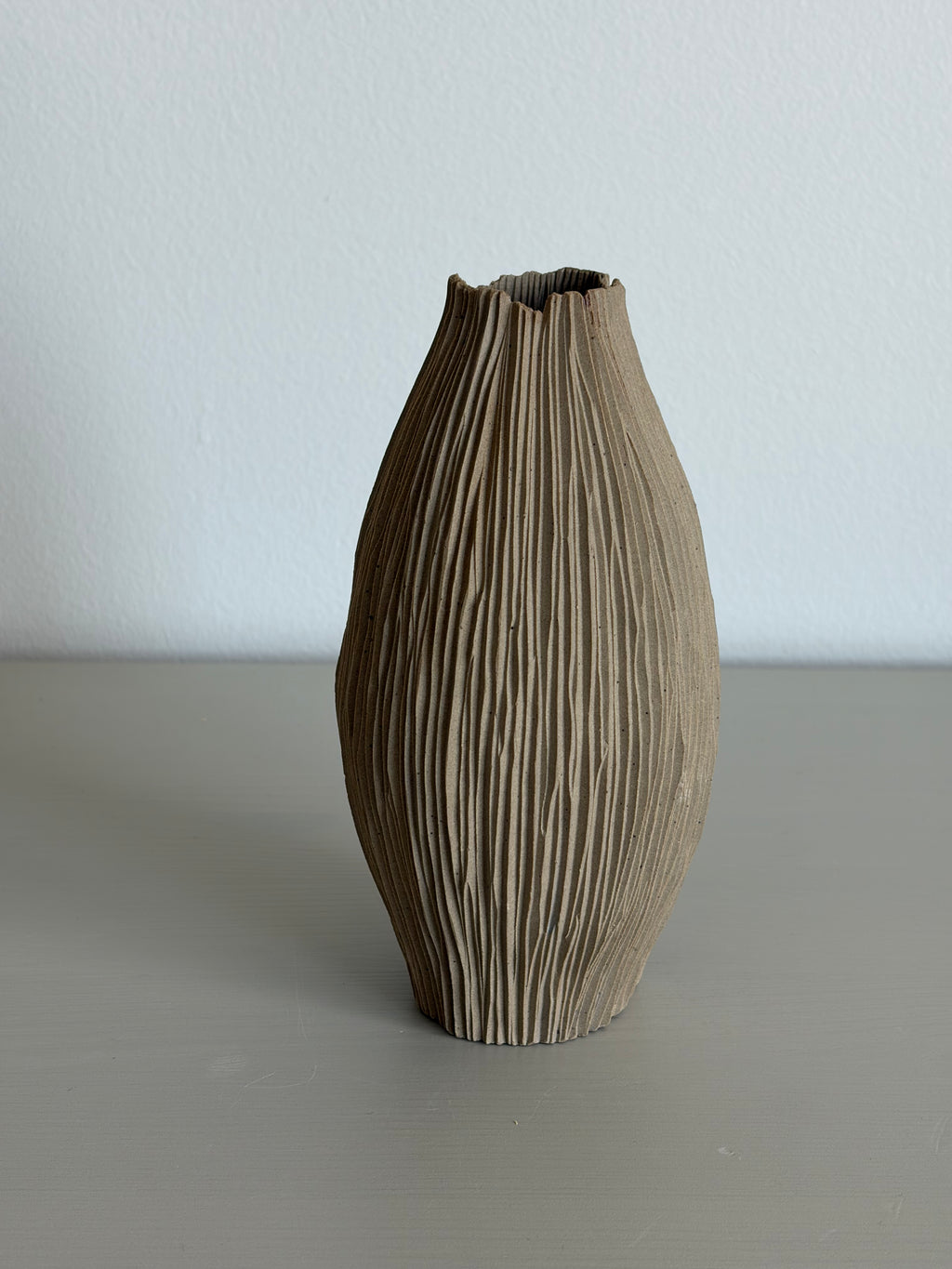 Slender tall seedpod vase