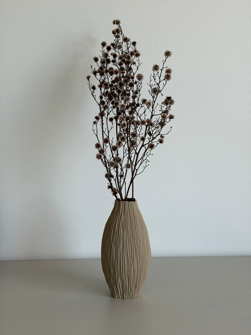 Slender tall seedpod vase